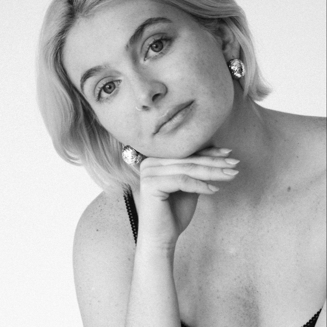 Model wearing the Cascade ball stud earrings in gold