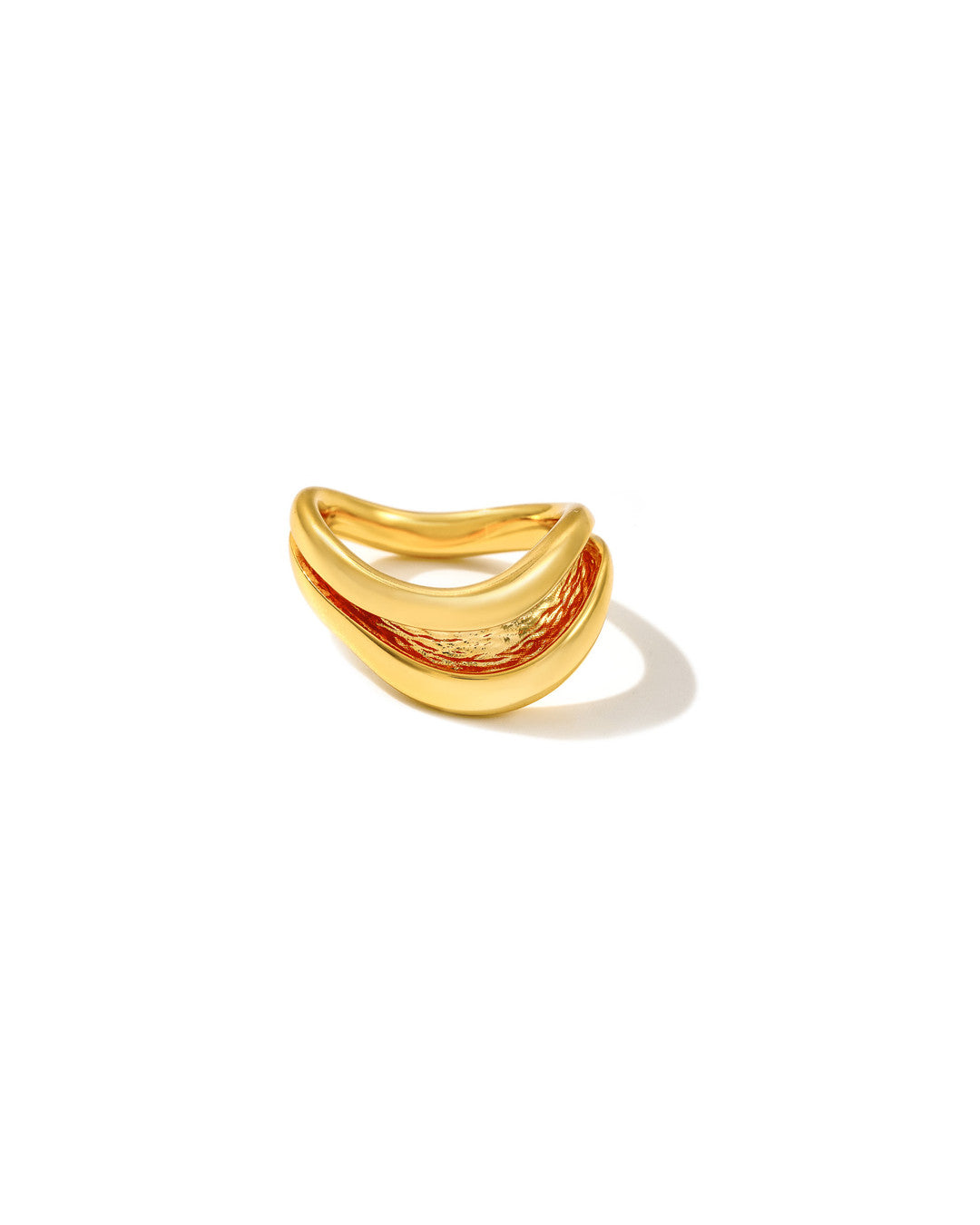 Gold Currents Wave ring with a smooth wave-form exterior and textured inner channel, on white