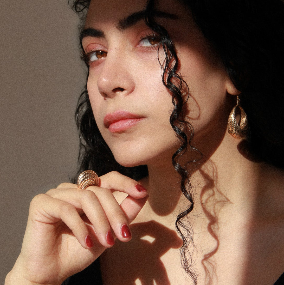 Model wearing the gold Flow Edgy Dome Ring