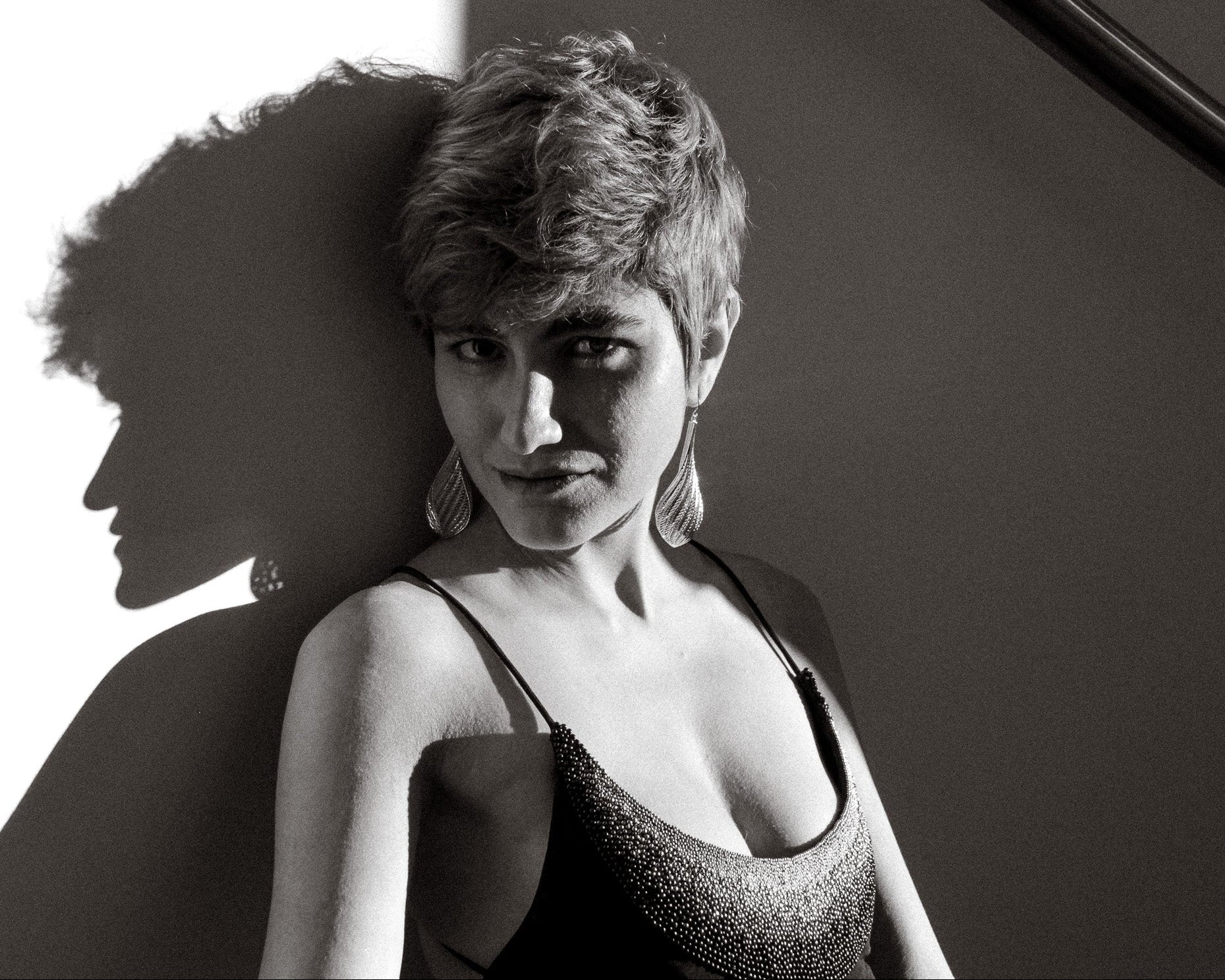 Model wearing the Flow large drop earrings in gold black and white