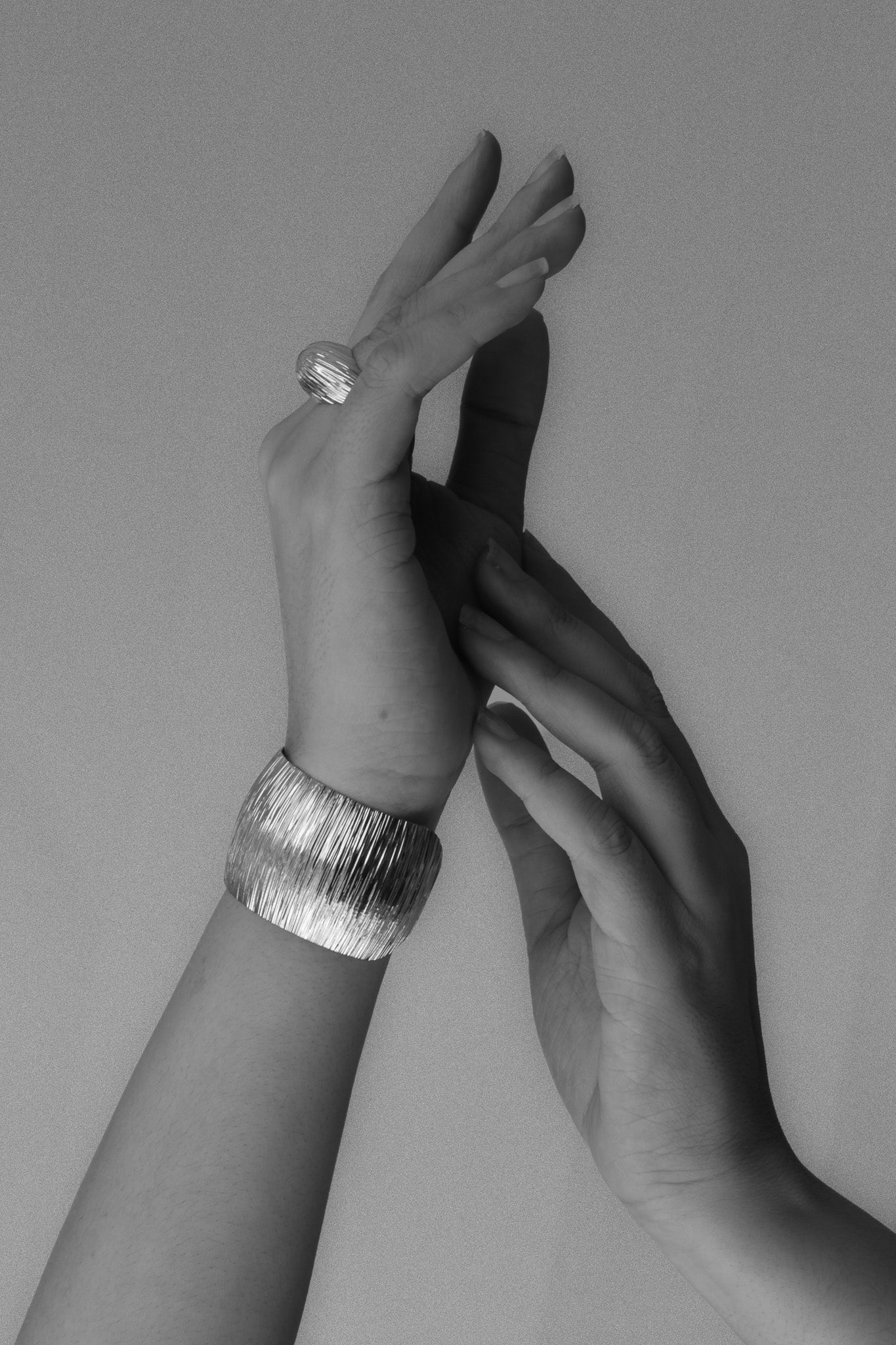 model_wearing_Cascade_Dome_Ring and bracelet with cascade texture and rhodium finish