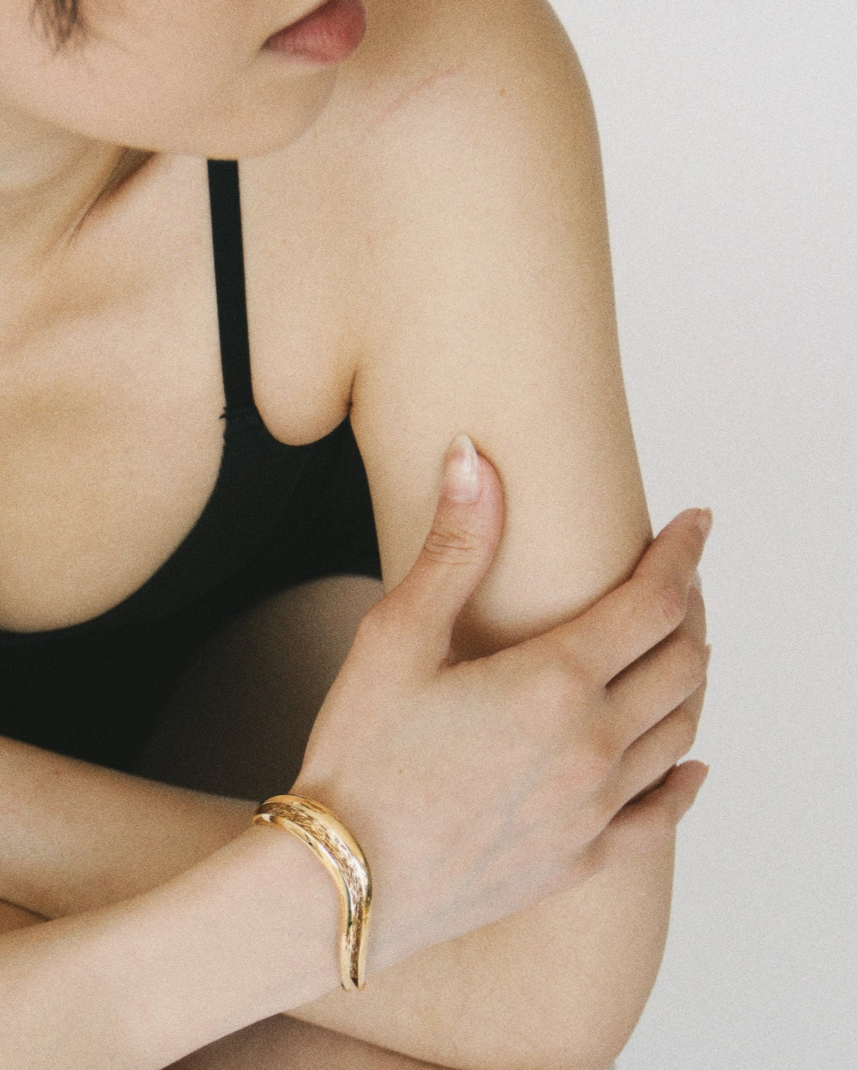 Gold open wave cuff bracelet with a smooth exterior and textured interior channel, Laminar Currents collection