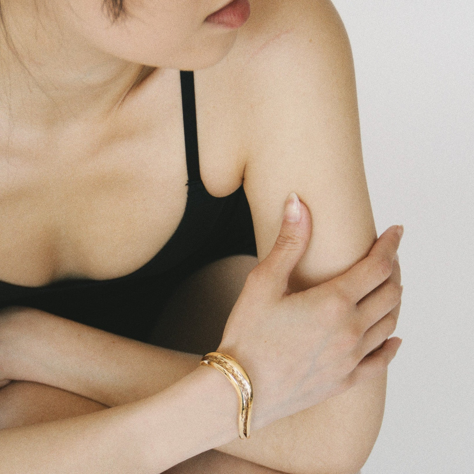 Gold open wave cuff bracelet with a smooth exterior and textured interior channel, Laminar Currents collection