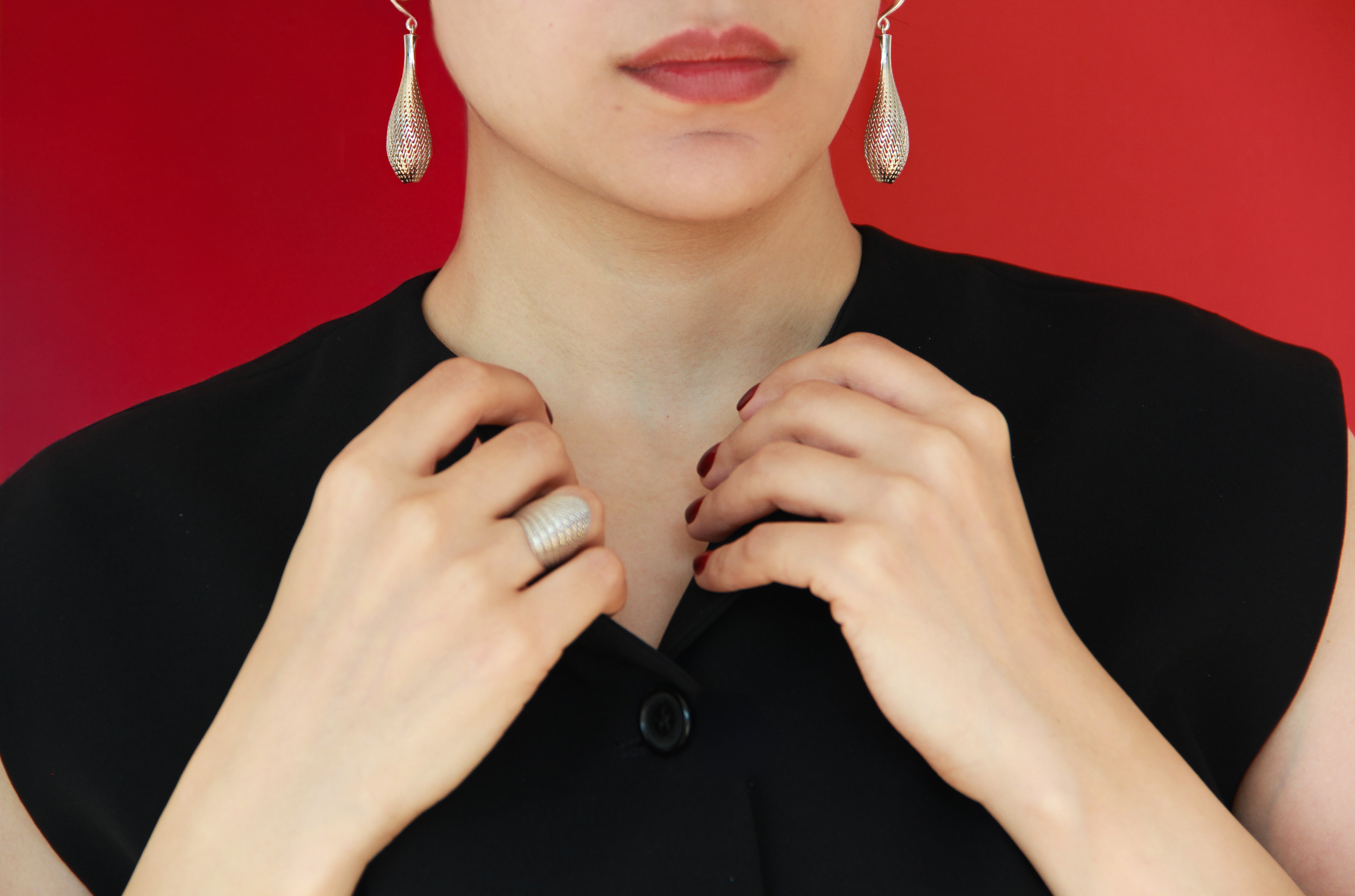 Model wearing Laminar Flow small drop earrings in gold