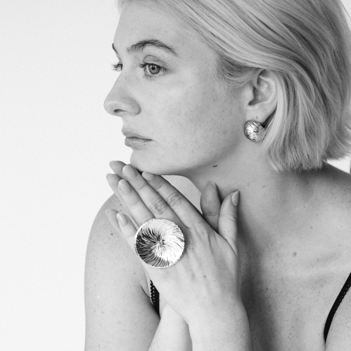 Model wearing the Cascade ball stud earrings in gold