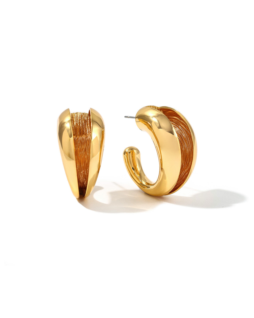 Gold Currents hoop earrings with a polished outer curve and textured inner surface, on white