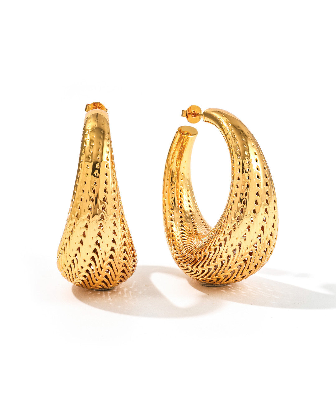 Large gold Flow hoop earrings with flowing lattice ridges and tapered teardrop shape, on white