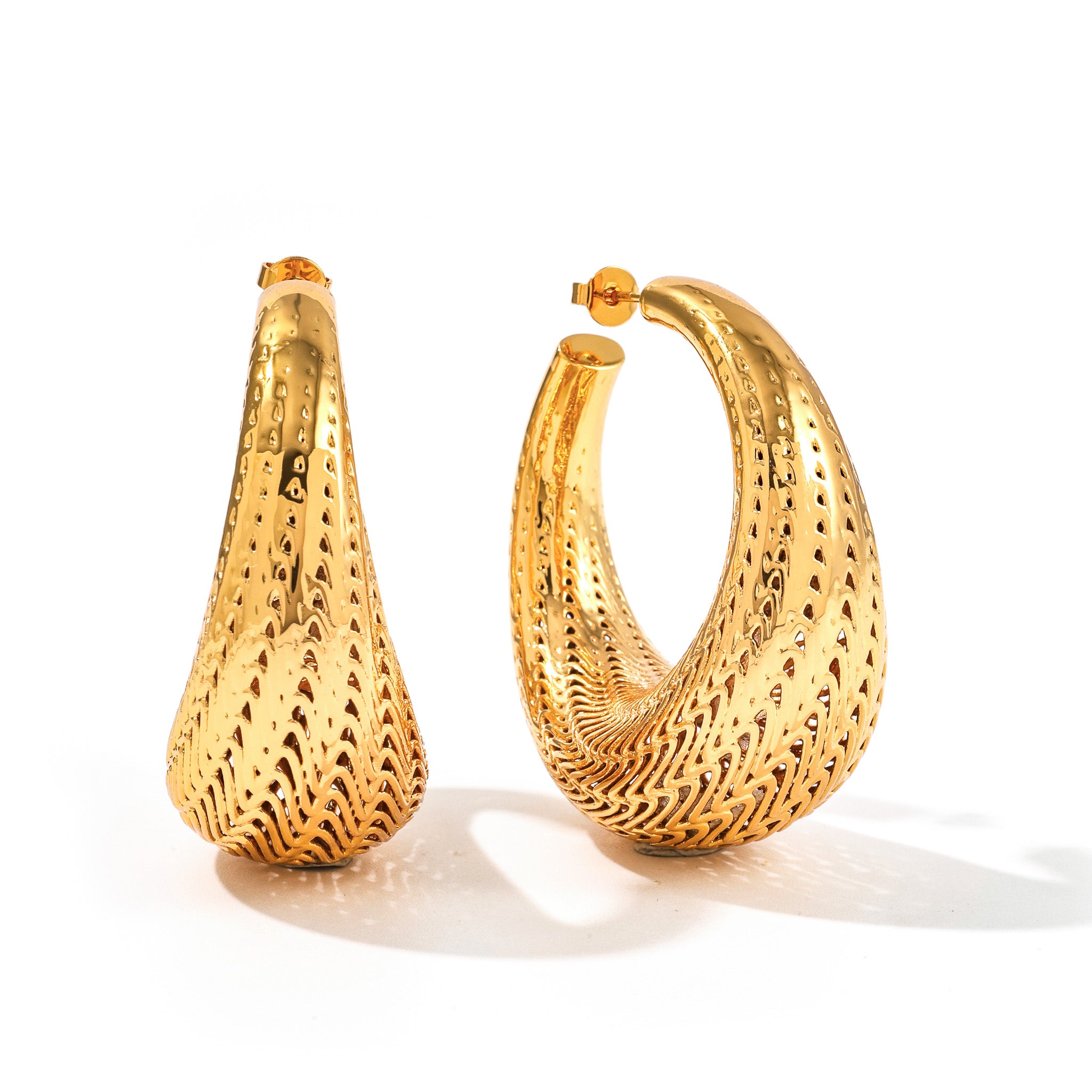 Large gold Flow hoop earrings with flowing lattice ridges and tapered teardrop shape, on white